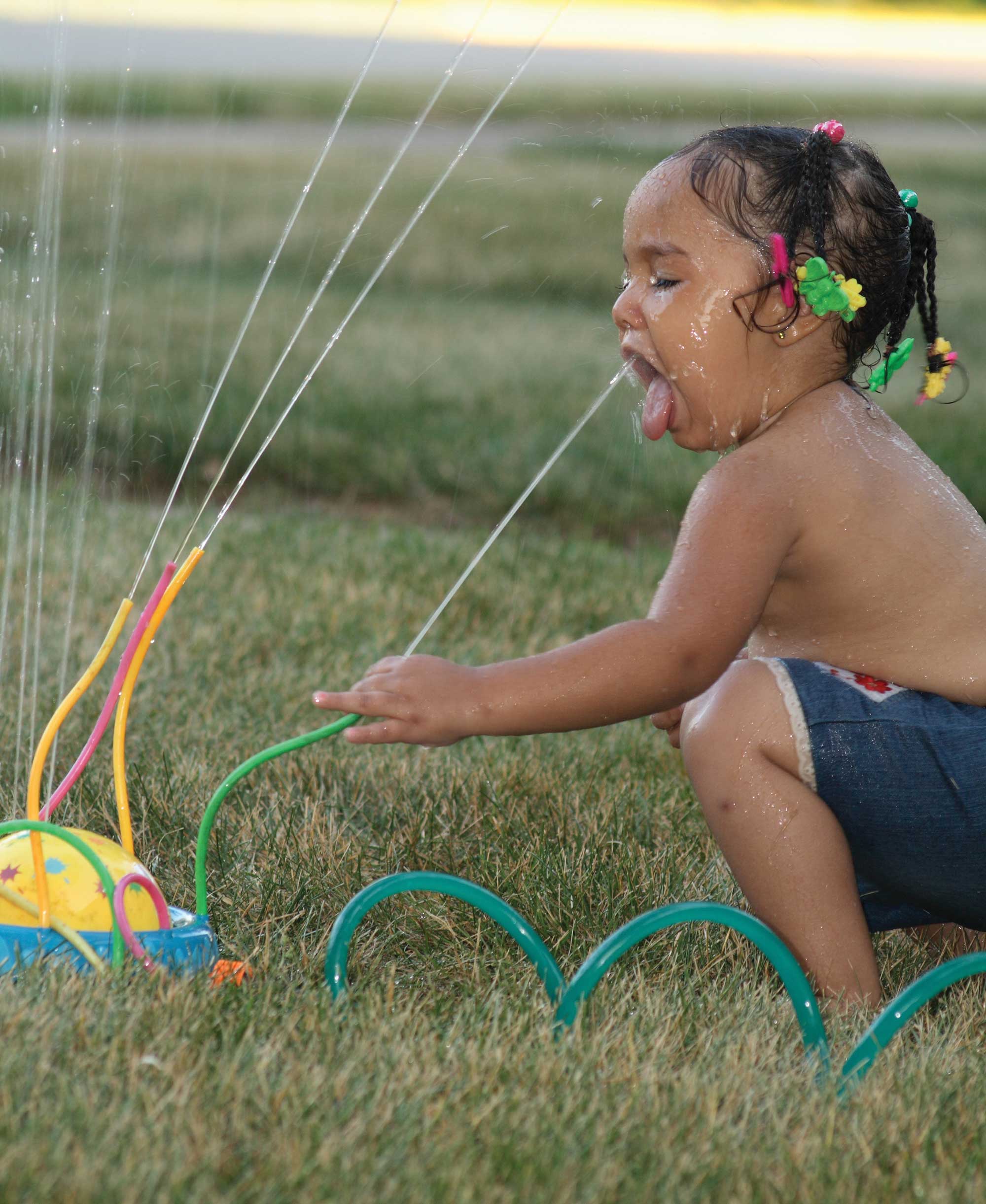 kids playing in sprinkler